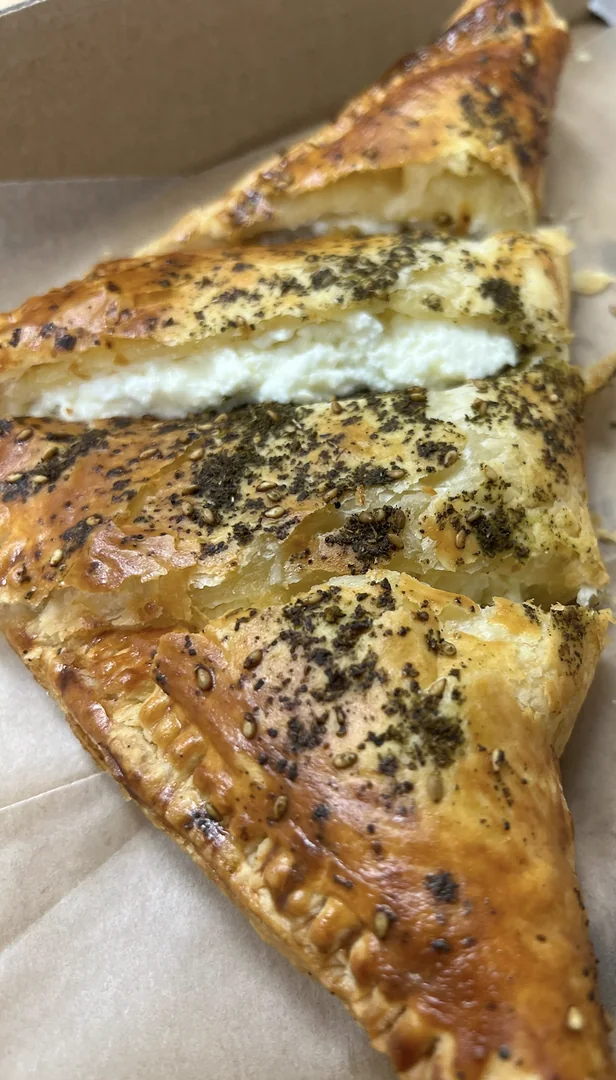 Classic cheese burekas cut open to show the cheese filling